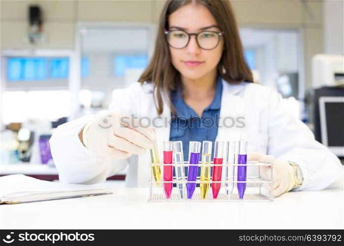 Beautiful young scientist working at the laboratory