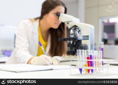 Beautiful young scientist working at the laboratory