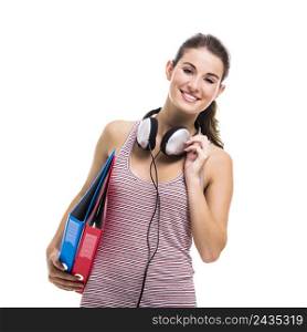 Beautiful young student with books and headphones, isolated over a white background