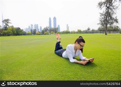 Beautiful young student woman study with tablet in park