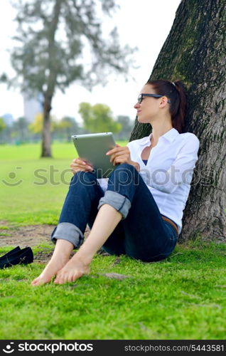 Beautiful young student woman study with tablet in park