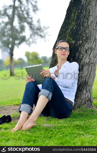 Beautiful young student woman study with tablet in park