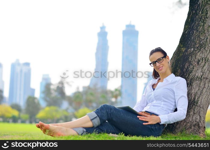 Beautiful young student woman study with tablet in park