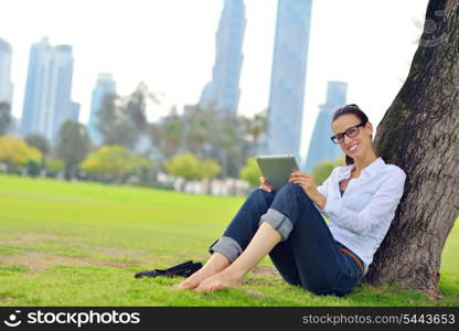 Beautiful young student woman study with tablet in park