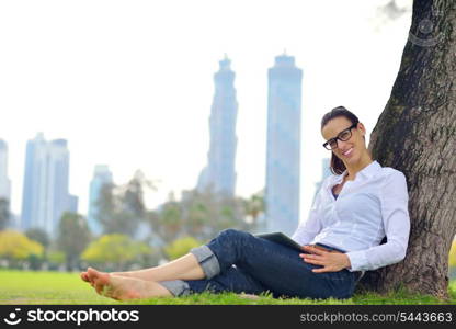 Beautiful young student woman study with tablet in park