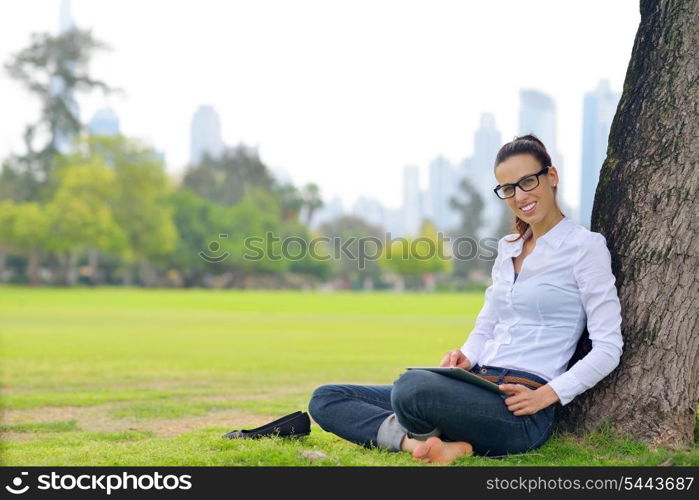 Beautiful young student woman study with tablet in park