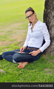 Beautiful young student woman study with tablet in park