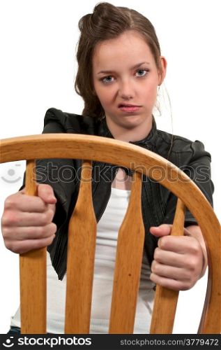 Beautiful young teenage girl siting in a chair breaking wind