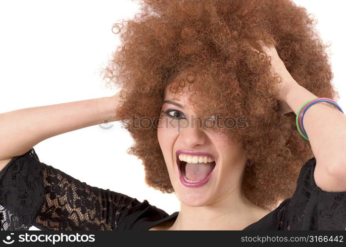 Beautiful young teenager screaming while holding her red afro wig