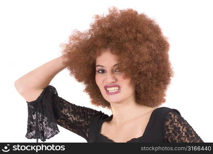 Beautiful young teenager with red afro wig pulling a face