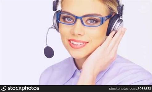 Beautiful young telesales lady wearing glasses and and a headset