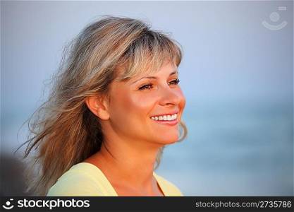 beautiful young woman against sea, Looking afar