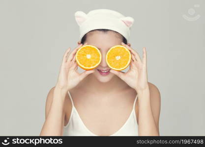 Beautiful young woman and an orange