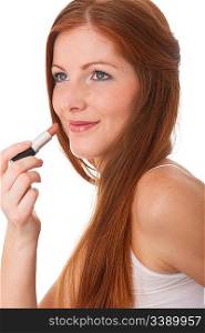 Beautiful young woman applying lipstick on white background