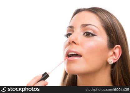Beautiful young woman applying makeup