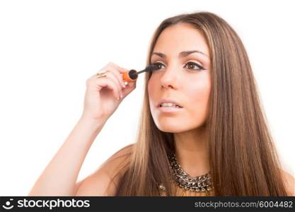 Beautiful young woman applying makeup