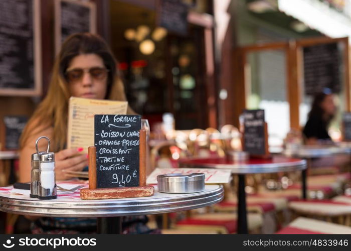 Beautiful young woman at a typical french restaurant