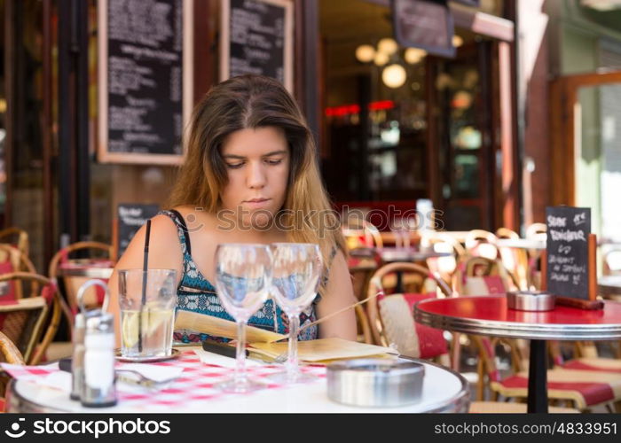 Beautiful young woman at a typical french restaurant