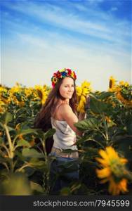 Beautiful young woman at sunflower field