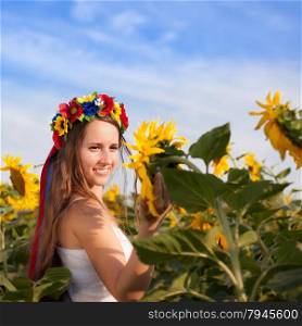 Beautiful young woman at sunflower field