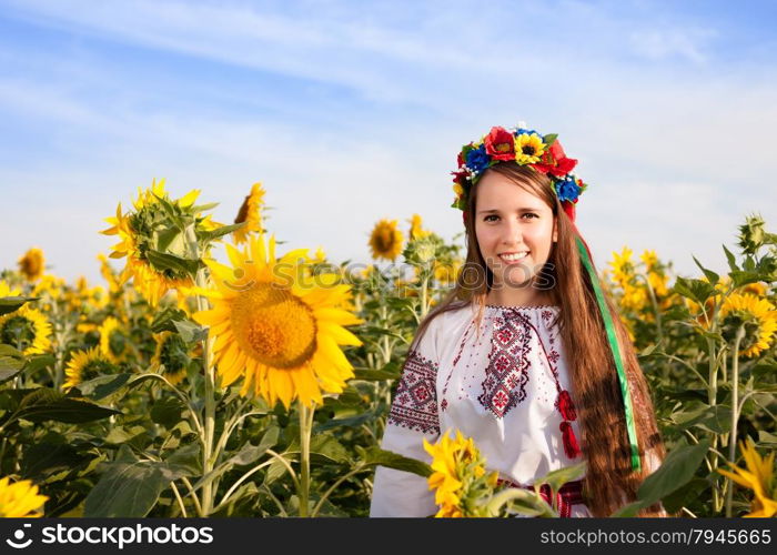 Beautiful young woman at sunflower field