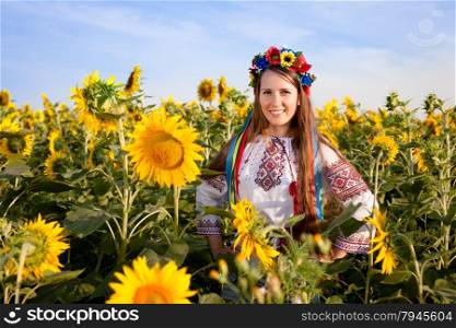 Beautiful young woman at sunflower field. Ukrainian woman