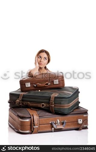 Beautiful young woman behind the baggage thinking on the vacations, isolated on white background