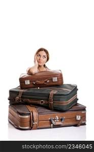 Beautiful young woman behind the baggage thinking on the vacations, isolated on white background