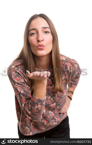 Beautiful young woman blowing you a kiss, isolated over white