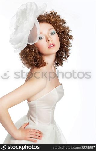 Beautiful young woman bride posing in white wedding dress with bow