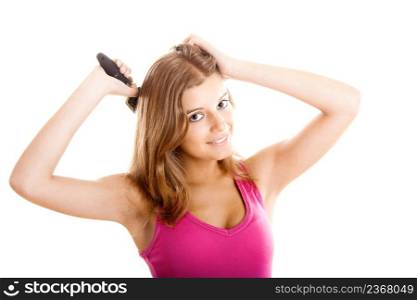 Beautiful young woman combs hair isolated on white