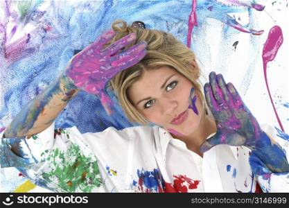 Beautiful young woman covered in paint. Shot in studio.