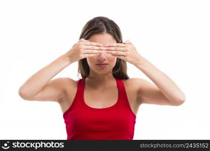 Beautiful young woman covering both eyes with her hands, isolated over a white background