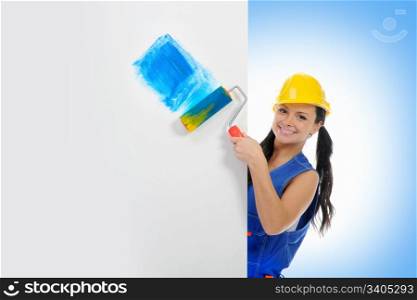 Beautiful young woman doing repairs on blue background