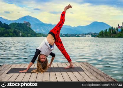 Beautiful young woman doing yoga in the park