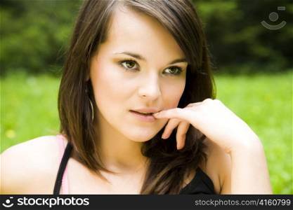 Beautiful young woman dreaming outdoors. Copy space.