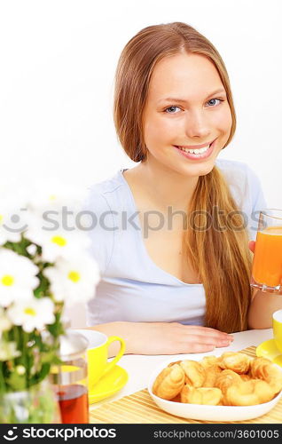 Beautiful young woman drinking tea from yellow cup