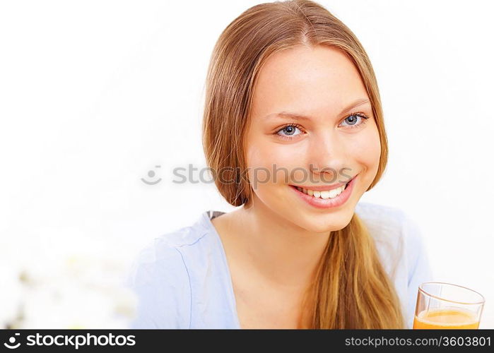 Beautiful young woman drinking tea from yellow cup