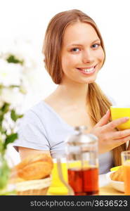 Beautiful young woman drinking tea from yellow cup