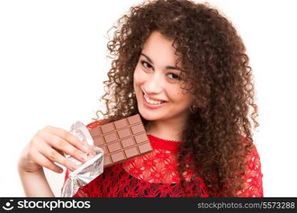 Beautiful young woman eating a chocolate bar