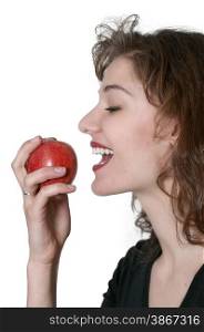 Beautiful young woman eating a fresh delicious apple