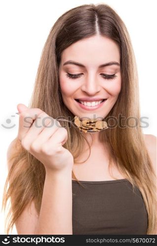Beautiful young woman eating cereals over white background