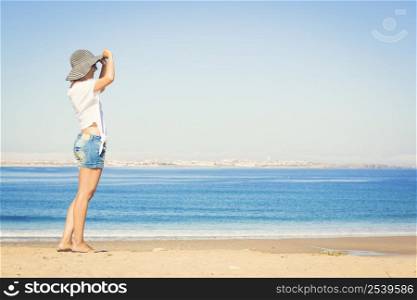 Beautiful young woman enjoying the beach