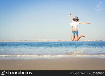 Beautiful young woman enjoying the beach