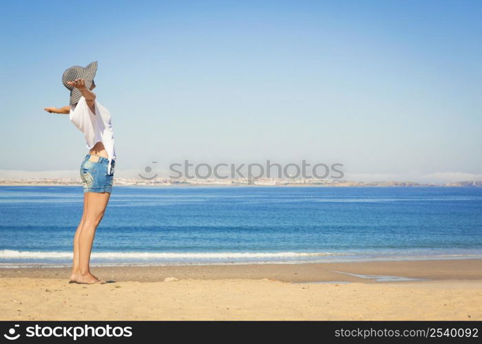 Beautiful young woman enjoying the beach