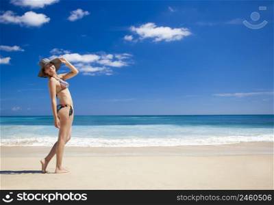 Beautiful young woman enjoying the summer in a tropical beach