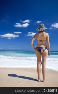 Beautiful young woman enjoying the summer in a tropical beach