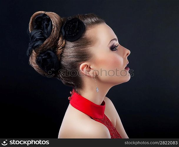 Beautiful young woman face with creative plait hairstyle looking