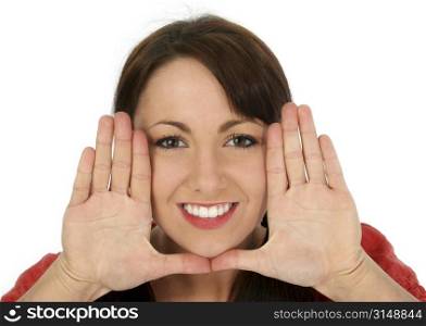 Beautiful young woman framing face with hands. Shot in studio over white.