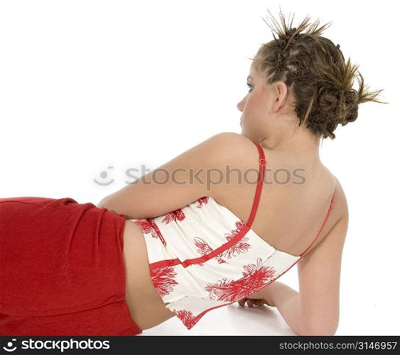 Beautiful young woman from behind. Laying on floor. Very stylish hair.